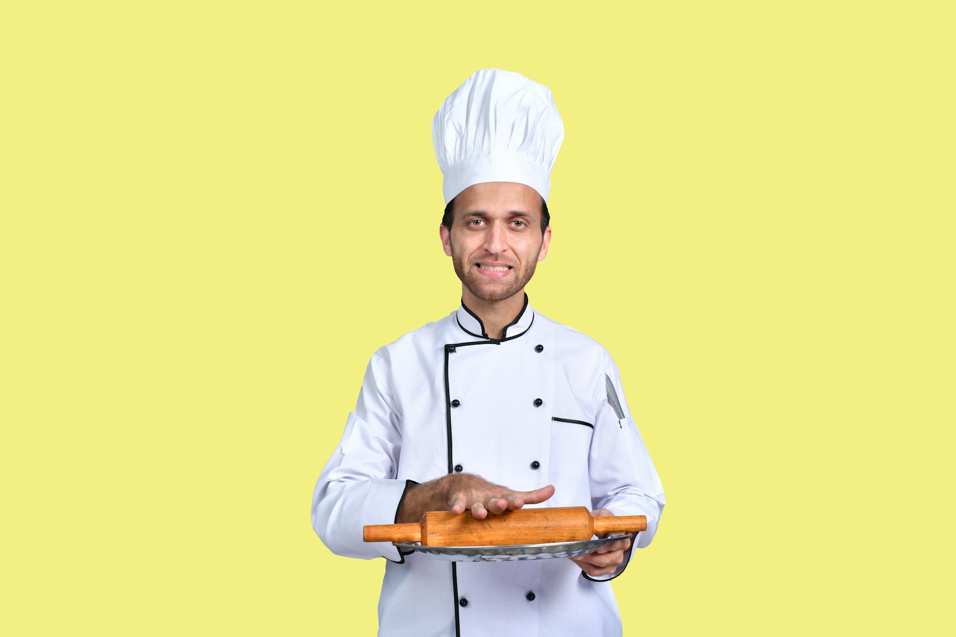 a man wearing a chef's hat and holding a tray